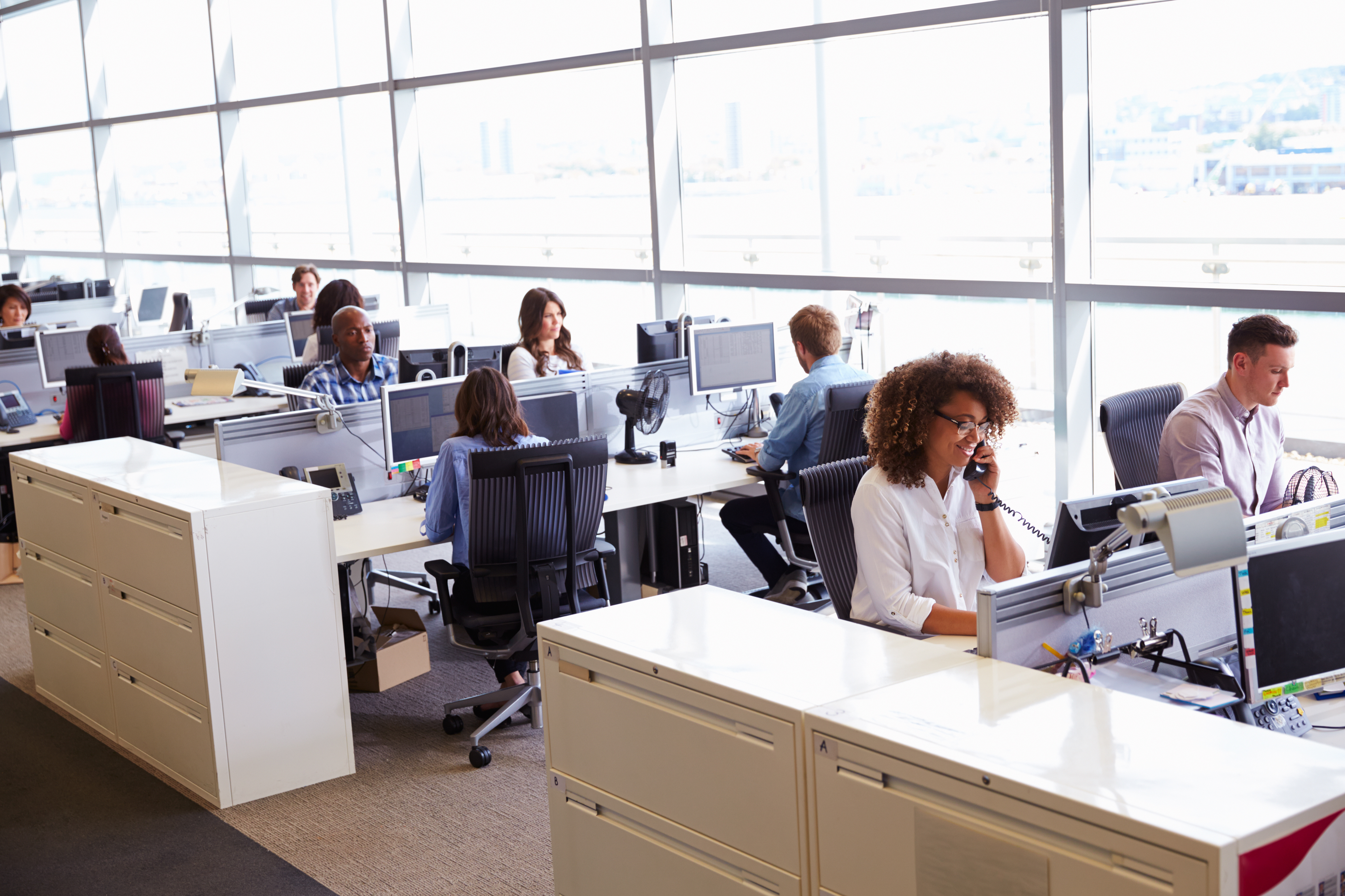 Image of an office with workers at desks